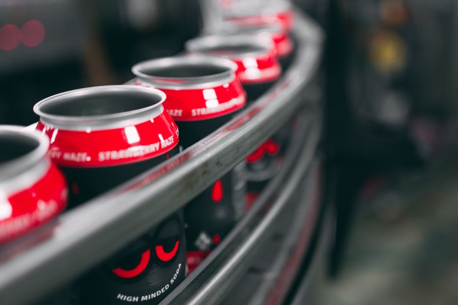 cans of drinks in an assembly line