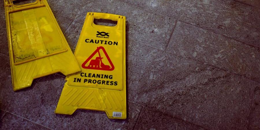 yellow caution cleaning sign, indoors, on the floor
